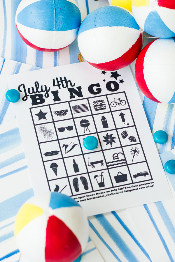 Free Printable 4th of July Bingo PDF Free printable 4th of July bingo page on a blue painted background with blue candy and beach balls.