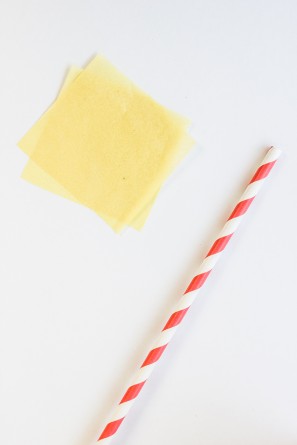 A stripped straw and yellow paper