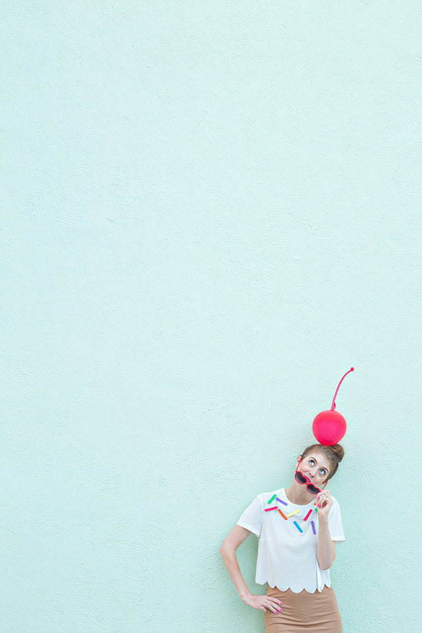 A person wearing a cherry hat