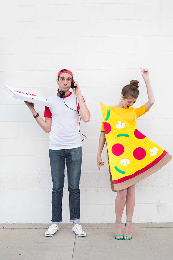 A woman dressed as pizza and a man in a delivery costume 