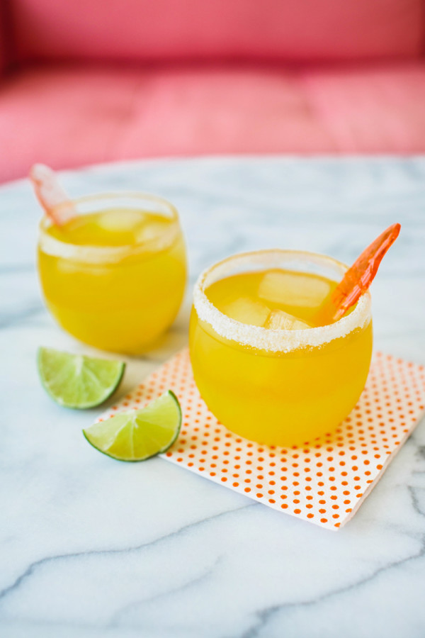 Cups with orange drink and limes next to it