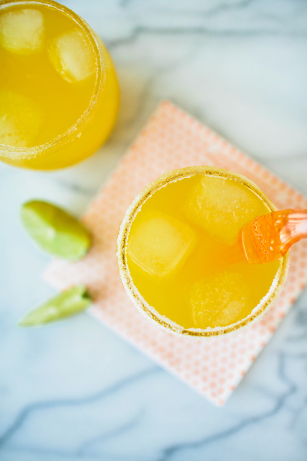 A cup with an orange liquid 