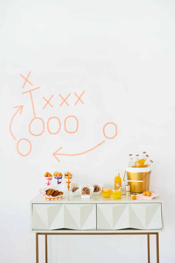 A dresser with snacks on it and tape on the wall