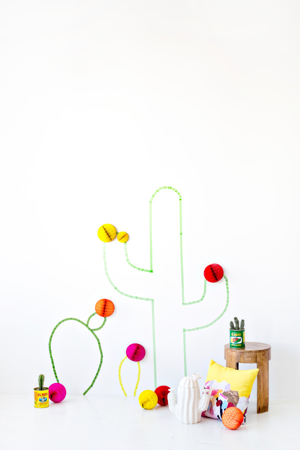 Cactus crafts on a wall with a table next to it