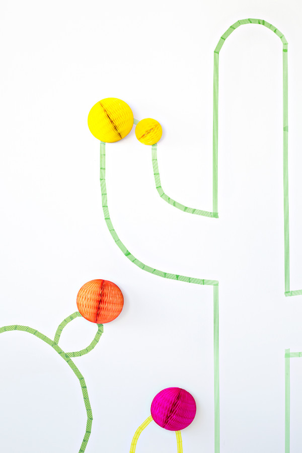 Orange and yellow paper spheres and green tape 