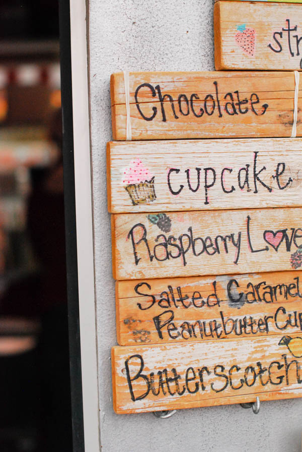 Wooden sign with black writing on it