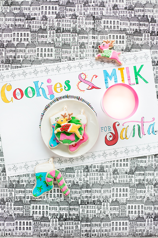 A place mat that says \"cookies and milk\" with bowls on it