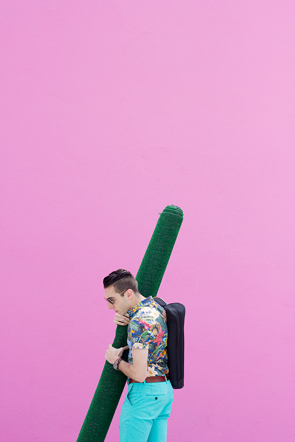 A man in front of a pink wall