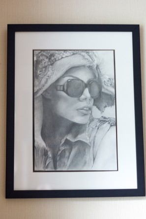 A drawing of a woman with glasses and a hat