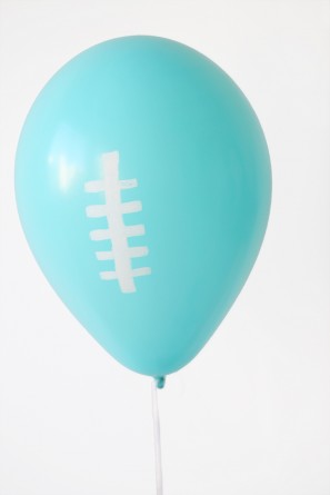 A blue balloon with white drawings on it
