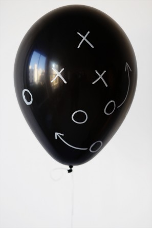 A black balloon with drawings on it