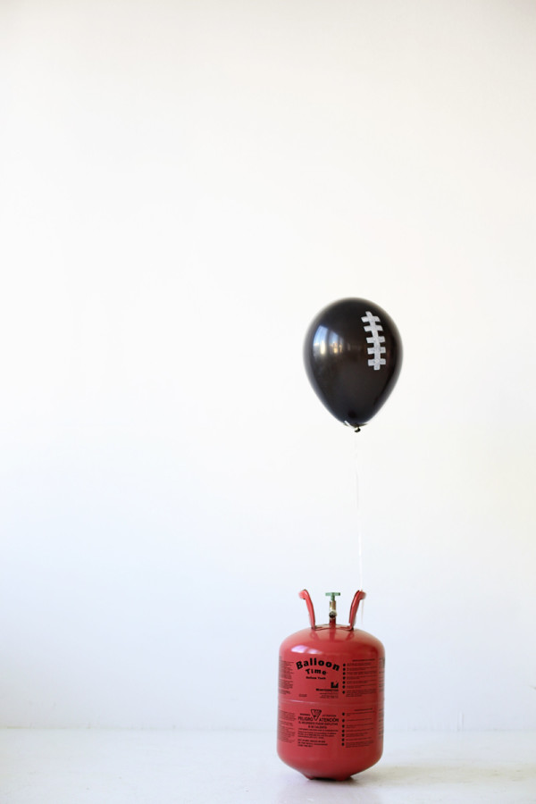 A black balloon with white drawings on it