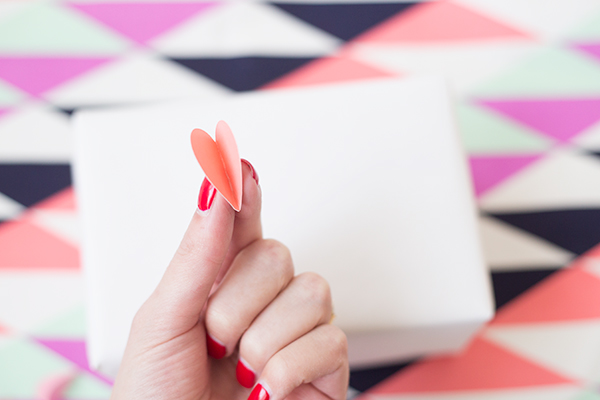 Someone holding a paper heart