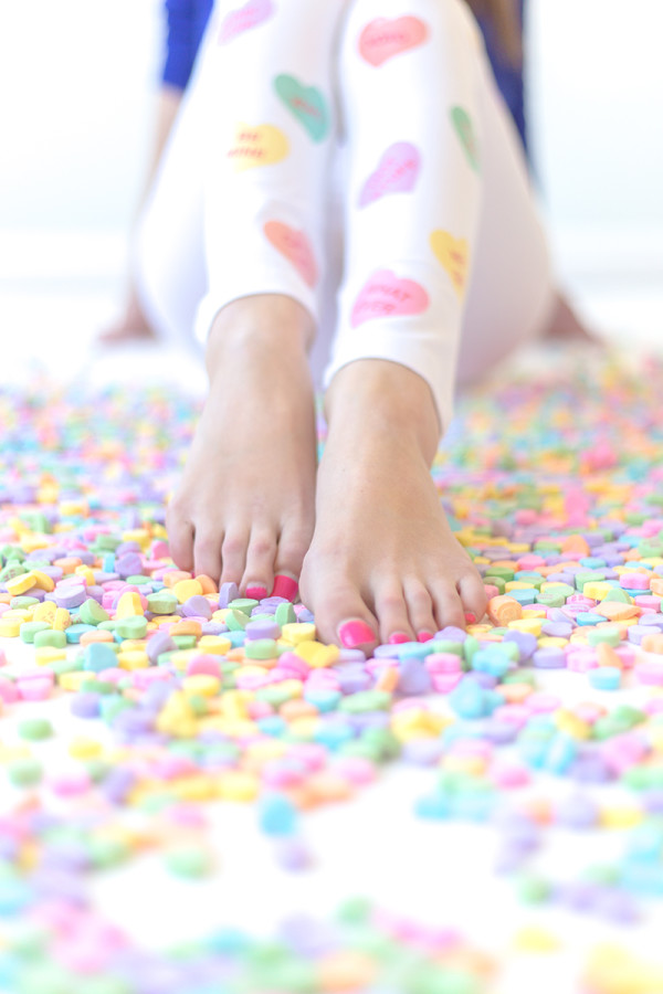 Someones feet and heart candies 