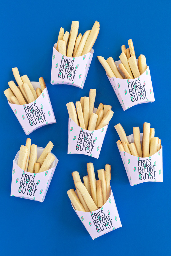 Fries in boxes that say \"fries before guys\"