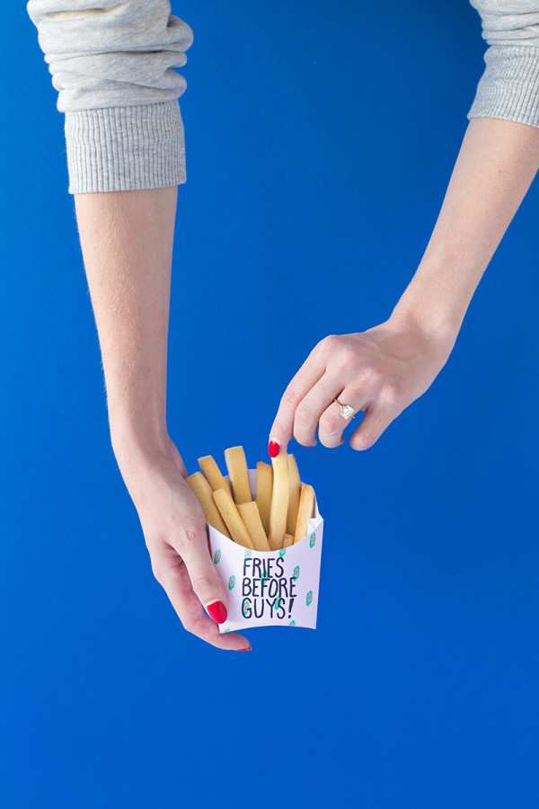 Someone holding fake fries