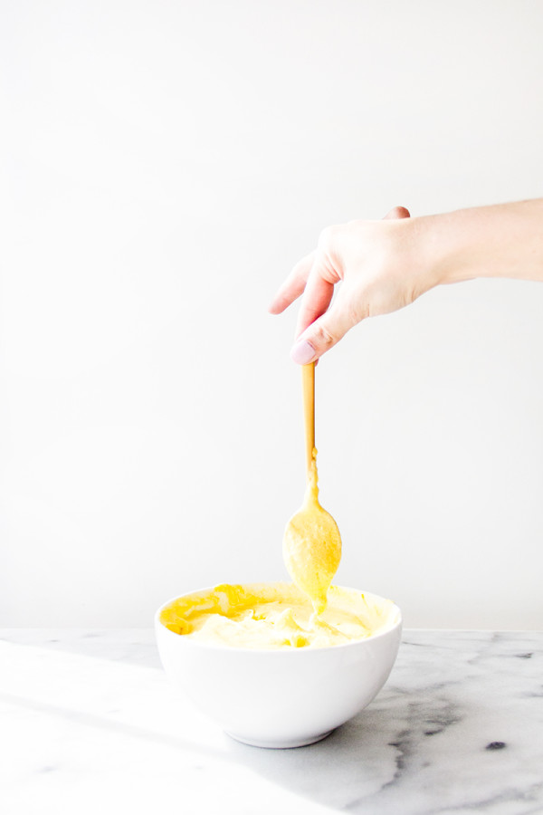 Someone holding a spoon in a bowl