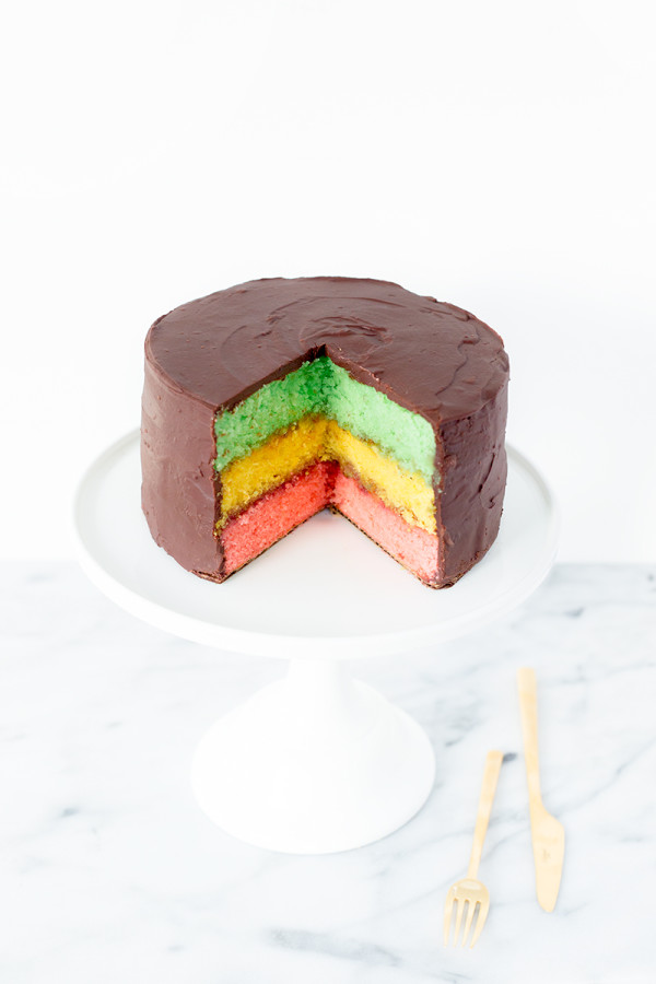 A cake on a plate with colorful layers