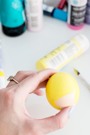 Someone holding a yellow egg