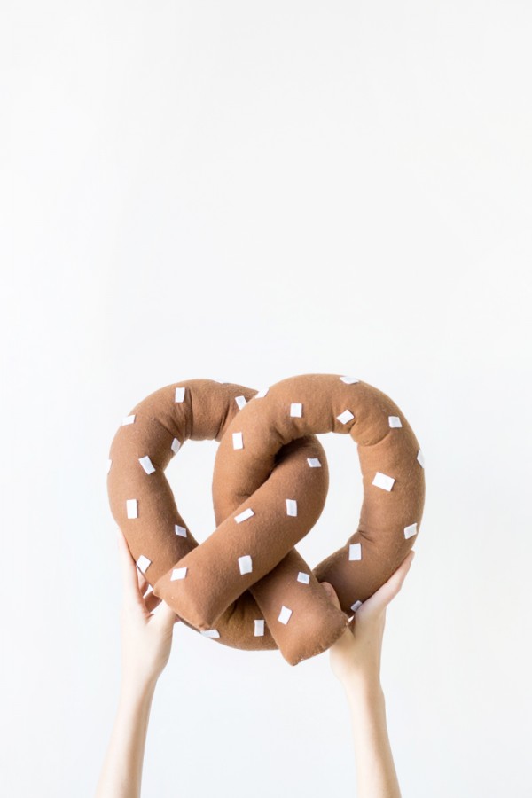 Someone holding a pretzel pillow