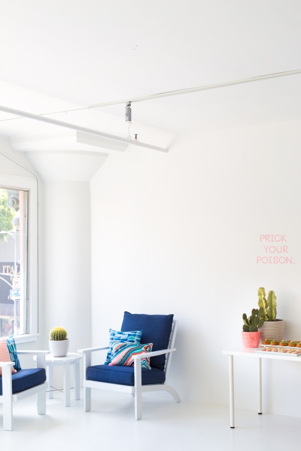 A white room with a blue chair