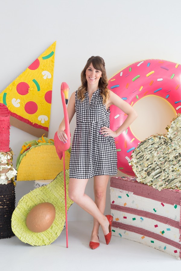 A woman standing next to a bunch of pool floaties