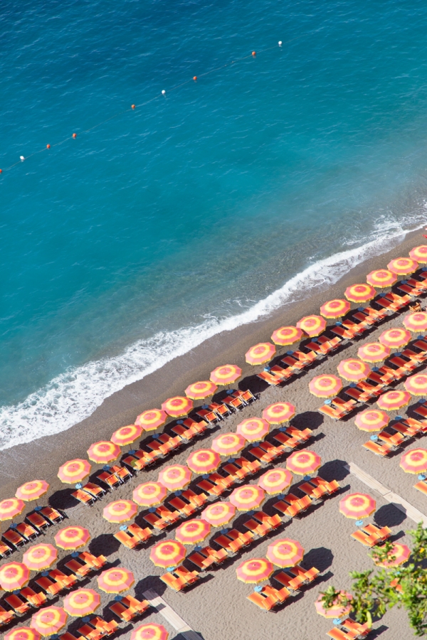 A beach with chairs and umbrellas