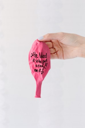 Pink balloon with words on it