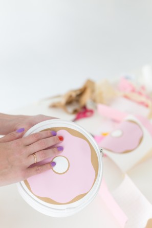 Someone holding a donut case