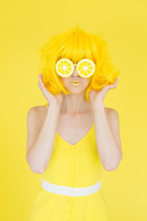 A woman with a yellow wig and lemon glasses