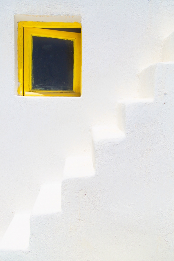 White stairs and a yellow window 