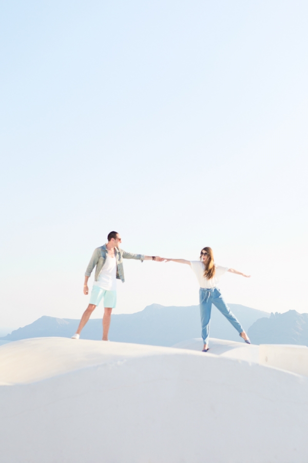 Two people standing on a white surface