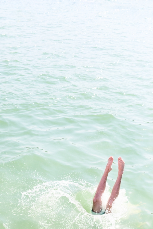 A close up of someones legs and water