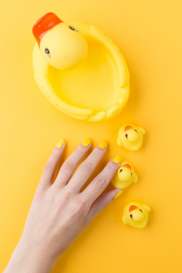 A hand and rubber duck