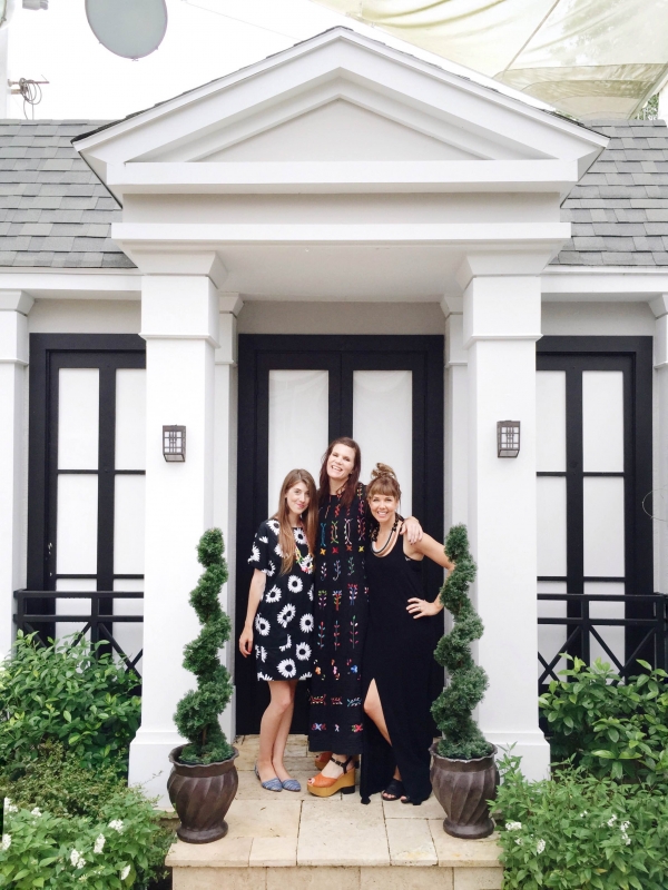 Three women standing in front of a building