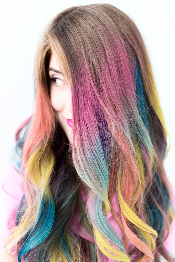 A close up of a woman with colorful hair
