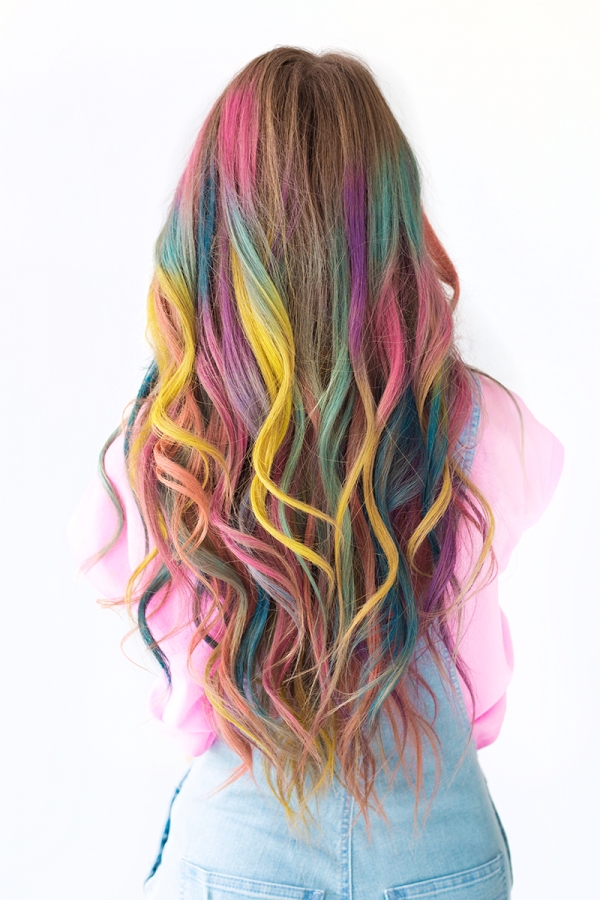 A close up of a girl with rainbow hair