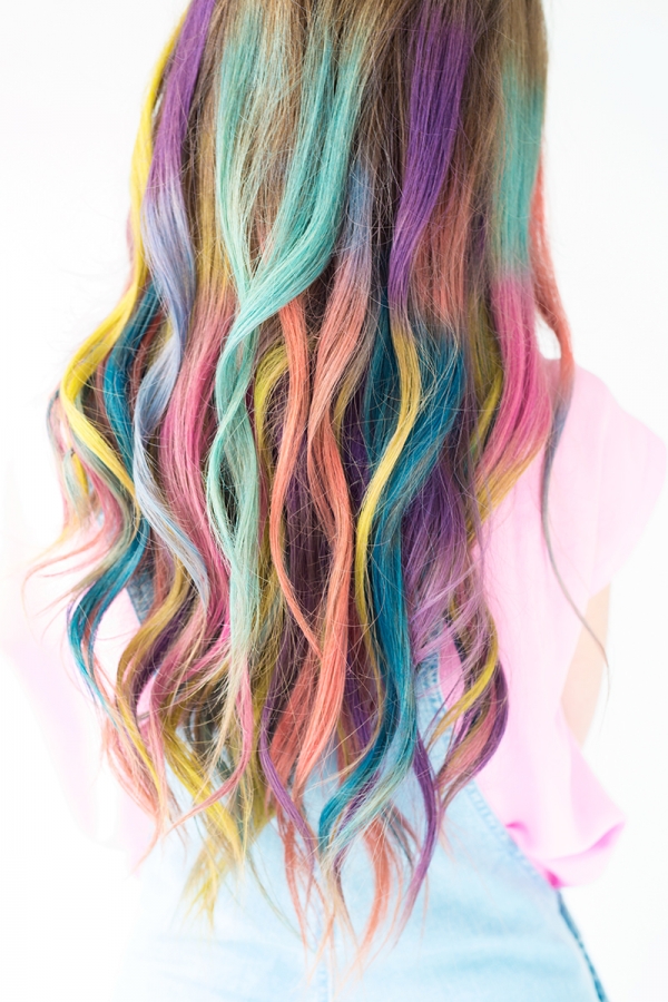 A close up of a person with rainbow hair