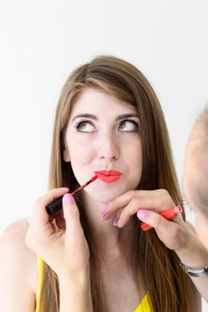 A woman putting lip product on