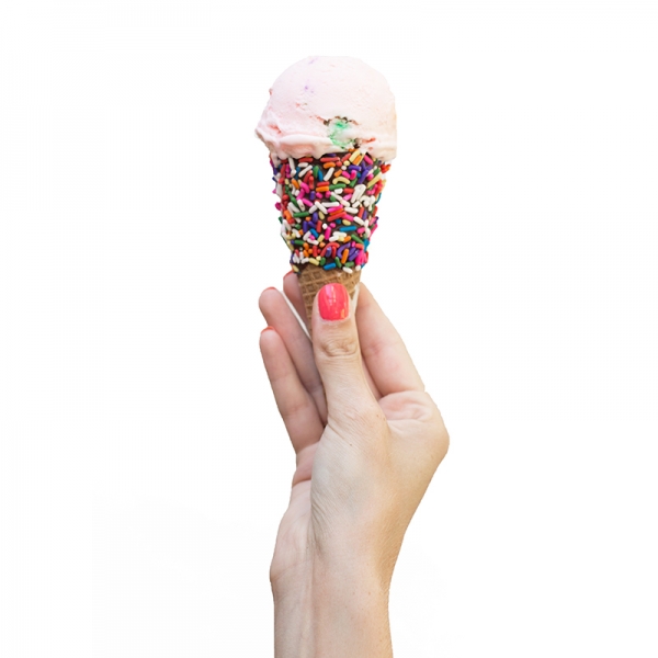 Someone holding a cone with ice cream