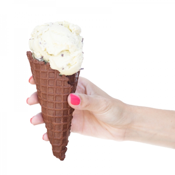 Someone holding a cone with ice cream