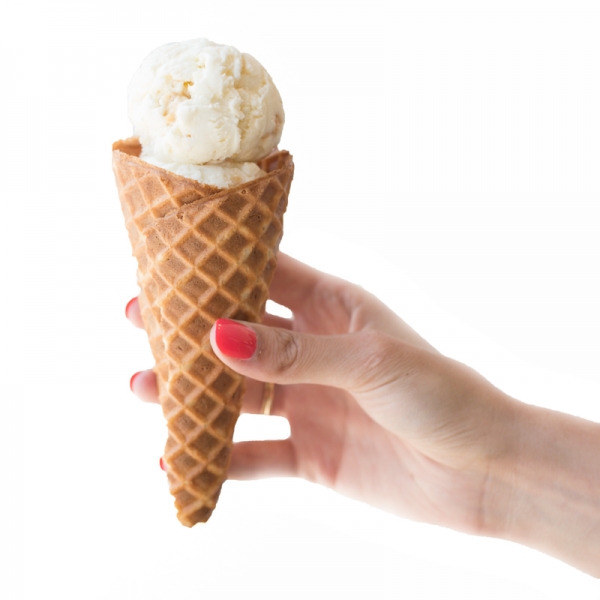 Someone holding a cone with ice cream