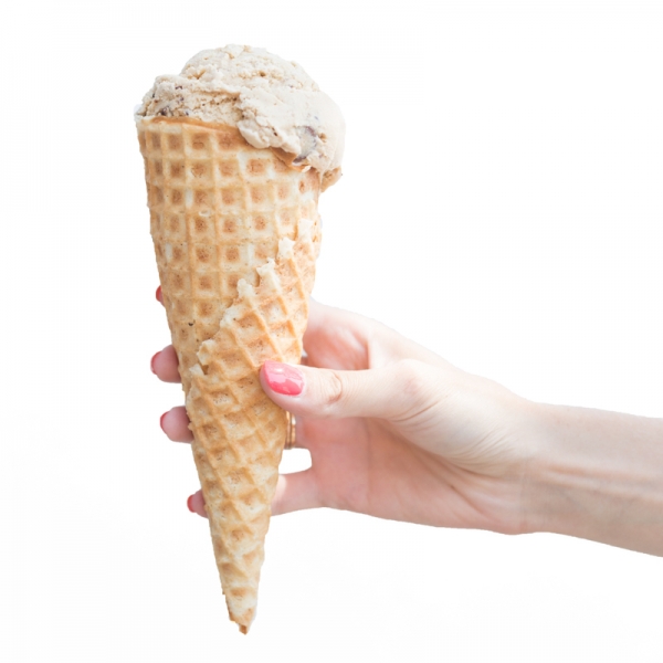 Someone holding a cone with ice cream