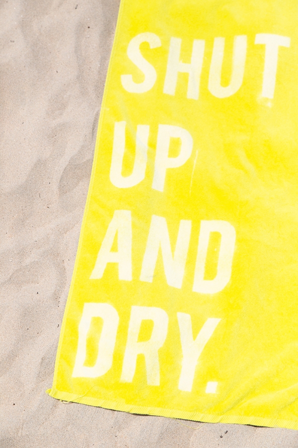 A close up of a yellow towel with words on it
