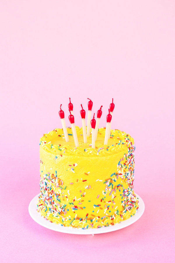 Yellow cake with candles on it