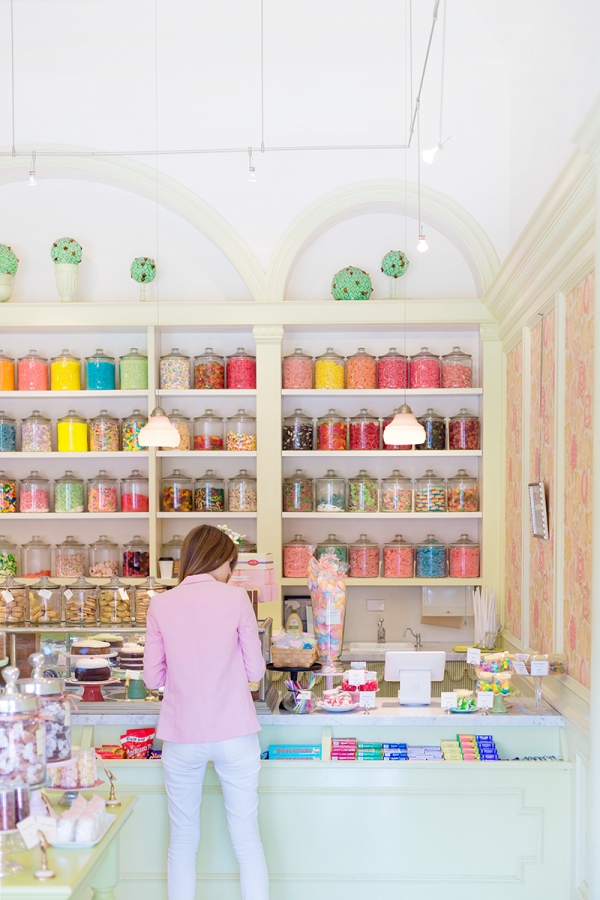 Someone in a store with jars of colorful things