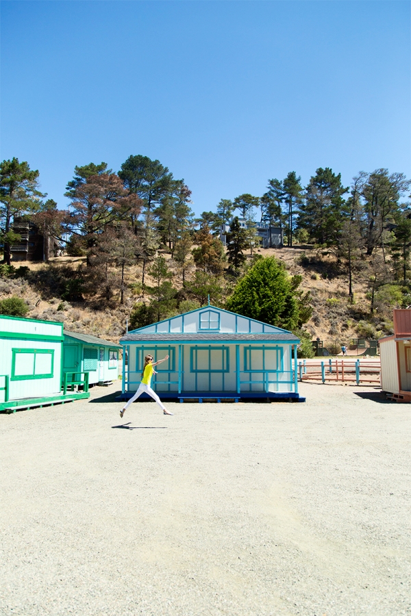 Someone in front of a small blue house