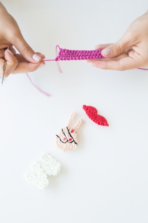 Someone crocheting little items 
