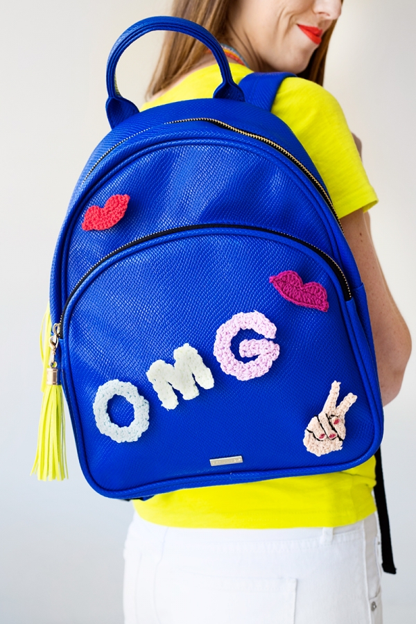 A blue backpack that says \"OMG\"