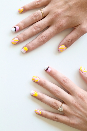 Someone with pink and yellow nails